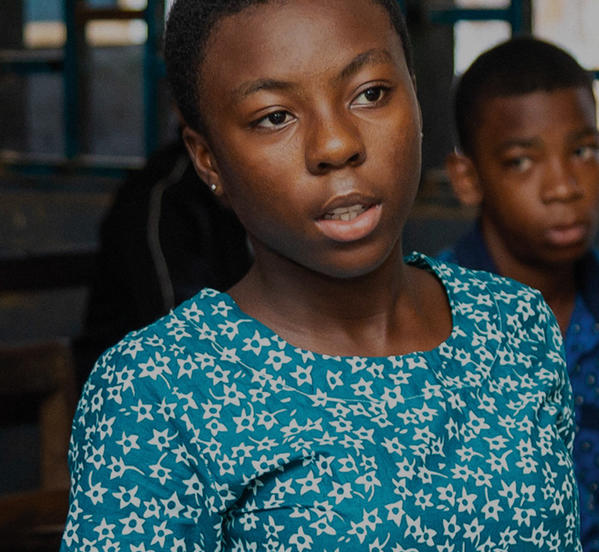 Female secondary school pupil in classroom in Ghana.