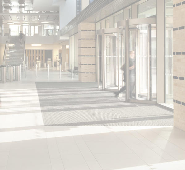 A woman walking through a contemporary office building.