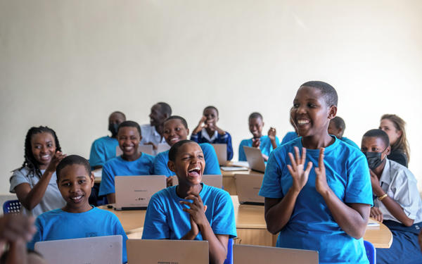 students applauding in a classroom in Rwanda