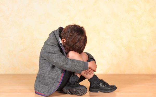 Boy crying in school uniform