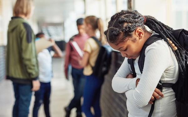 Student sad in school corridor