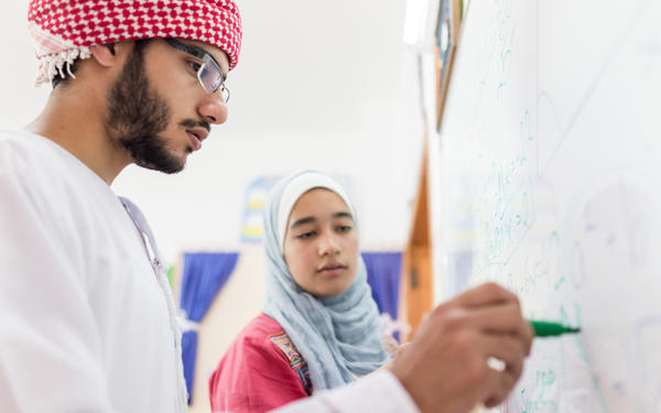 Arabic teenagers at whiteboard