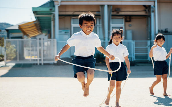 Boy in playground with skipping rope