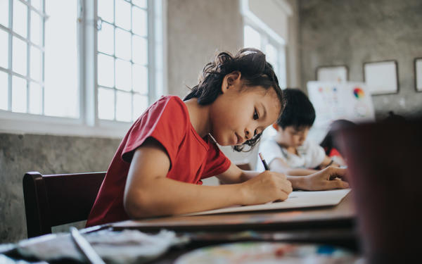 Girl in classroom writing
