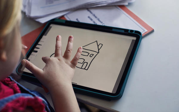 Student drawing home on tablet