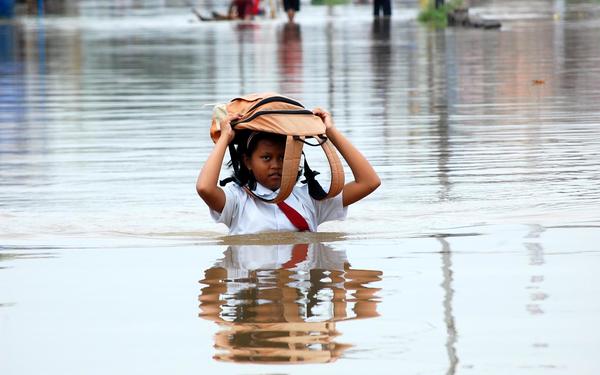 Young student in flood water