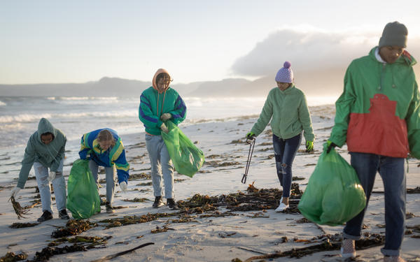 students litter picking on beach