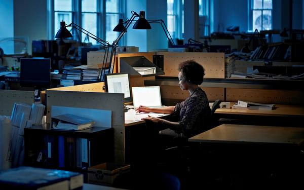Women works at computer late at night