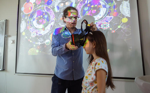 Student having a VR headset placed on her head