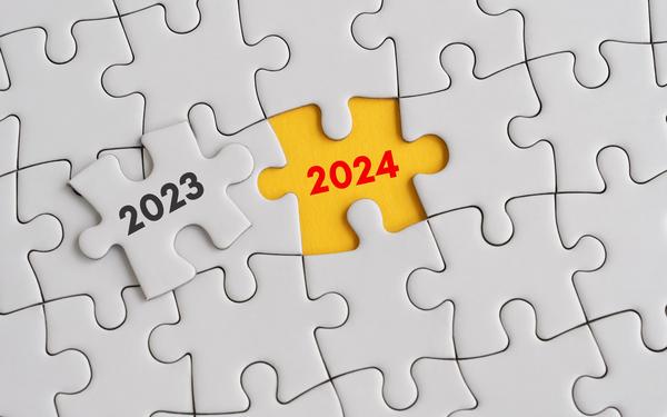 Puzzle with 2023 piece lifted to reveal 2024 underneath