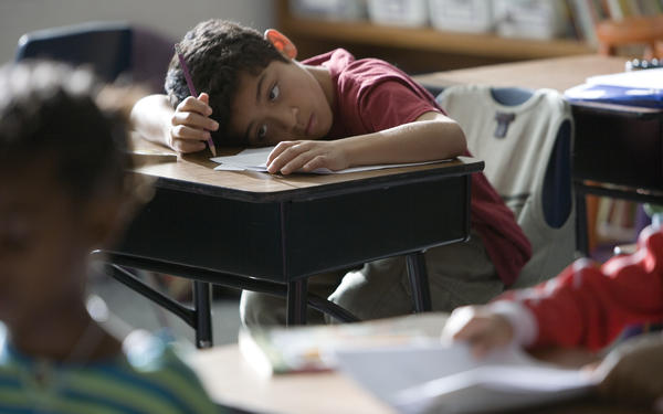 Boy looks bored in classroom