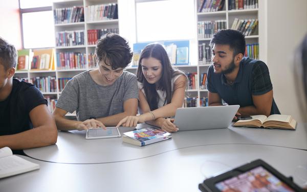 Group of three students online learning with a laptop and ipad
