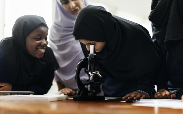 Students around microscope