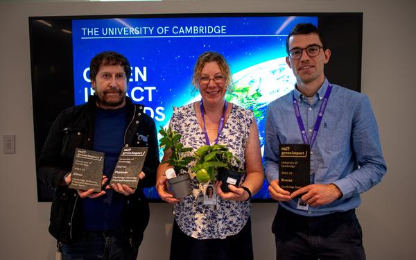 Cambridge colleagues holding Green Impact awards and prizes