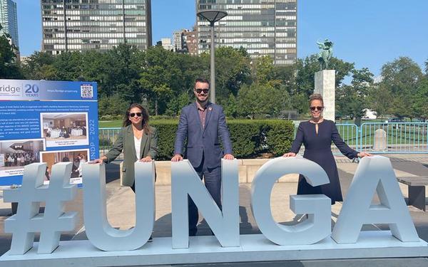 Cambridge colleagues behind a #UNGA sign