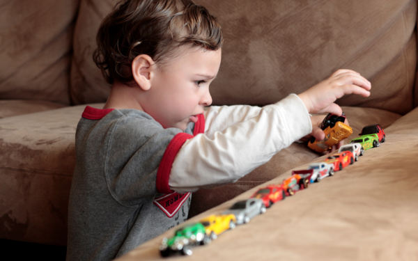 Autistic boy lines up cars to create order in his world