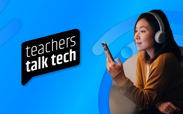 woman wearing headphones looking at mobile phone