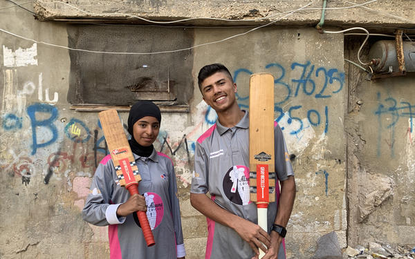 Two Alsama students in cricket kit