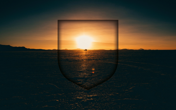 silhouette photography of land with a shield stamp over