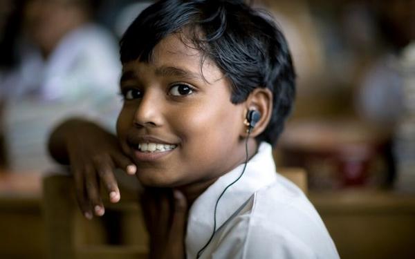 Boy listening through headphones