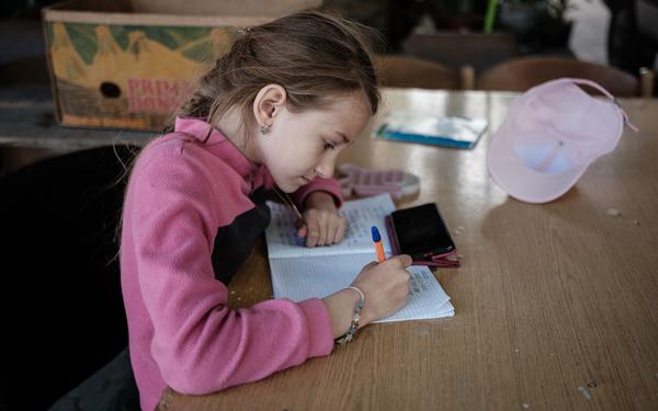 Young girl writing in a notebook