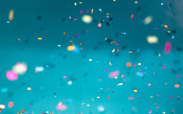rainbow confetti over a blue background