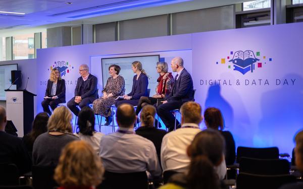 6 panel members seated on stage at the Digital and Data Day 2024 main stage