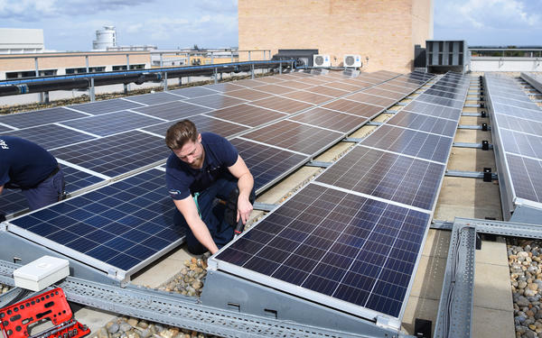 Colleagues working on solar panels