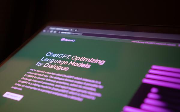 Laptop screen showing the homepage of ChatGPT. Large text reads: "ChatGPT Optimizing Language Module for Desktop"