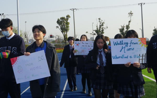 group of students in China walking and holding a poster
