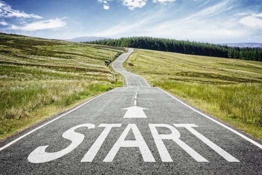 A rural road set within rolling hills featuring the word 'Start' on it