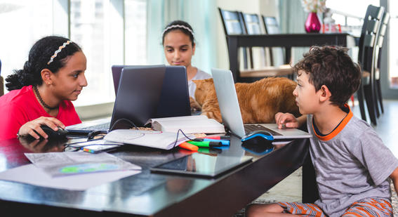 Children learning with laptops in the UAE