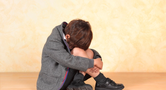 Boy crying in school uniform