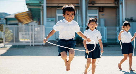 Boy in playground with skipping rope