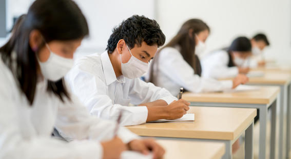 students wearing masks at classroom desks 