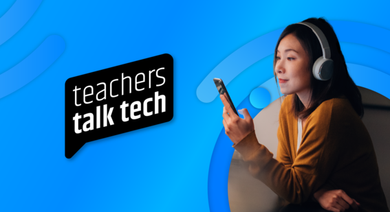 woman wearing headphones looking at mobile phone