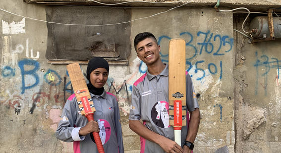 Two Alsama students in cricket kit