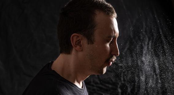 Photograph of a man coughing