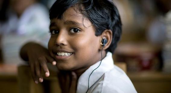 Boy listening through headphones