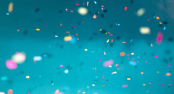 rainbow confetti over a blue background