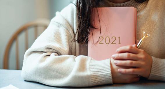 Teacher holding a 2021 diary and a pen