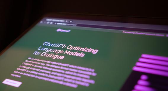 Laptop screen showing the homepage of ChatGPT. Large text reads: "ChatGPT Optimizing Language Module for Desktop"