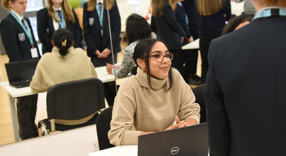 Cambridge colleague with school students during a careers carousel